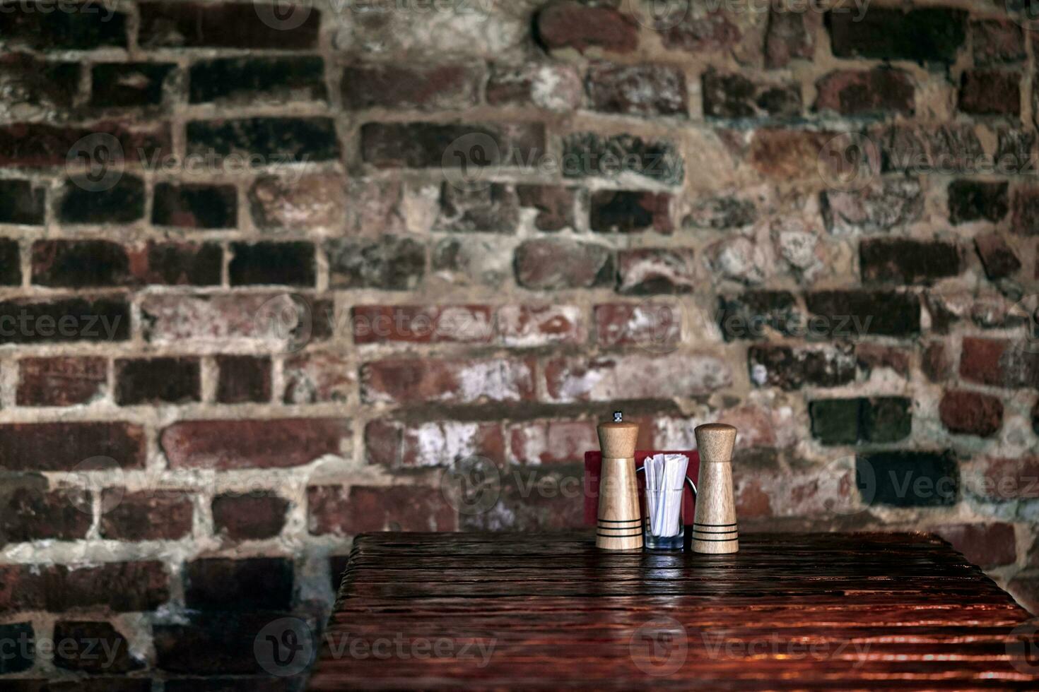 Empty wooden deck table with vintage brick wall pattern. photo