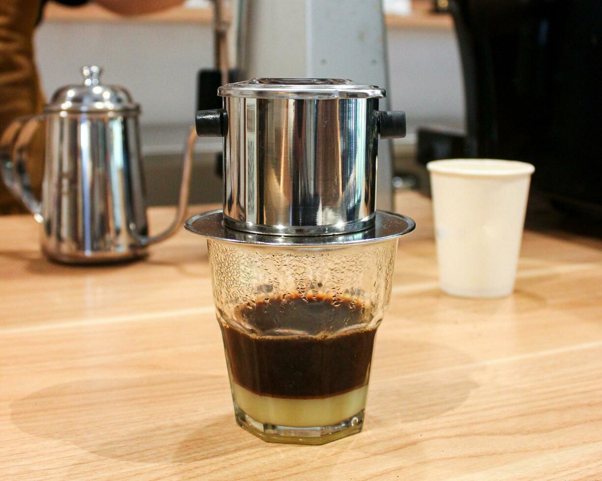 Vietnam Style Drip Coffee with Condensed Milk at the Bottom to Add Sweetness, Close Up photo