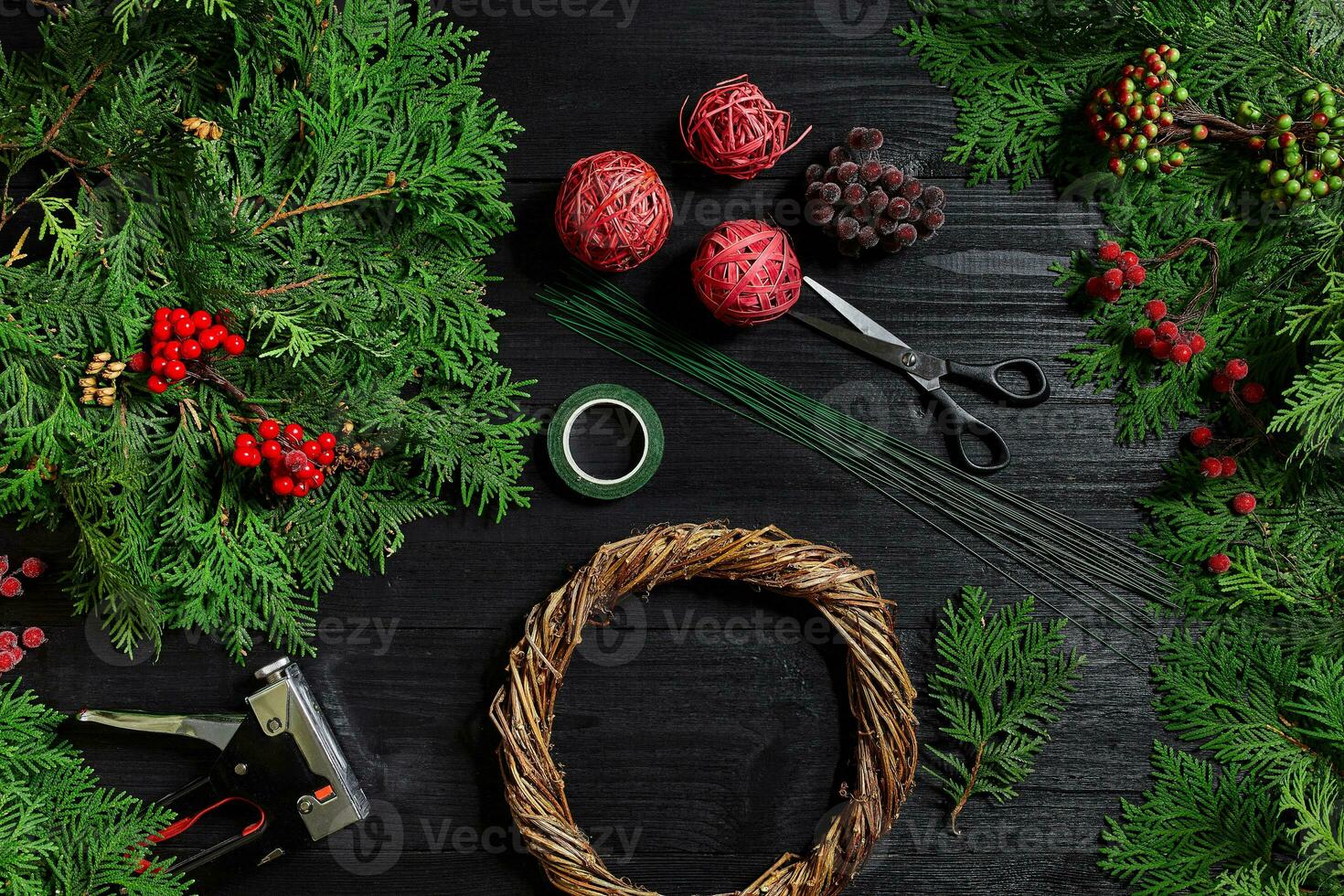 Manufacturer of Christmas decor with their own hands. Christmas wreath for the holiday. The new year celebration. Top view photo