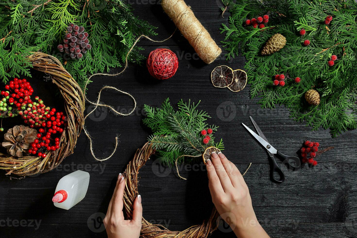 Manufacturer of Christmas decor with their own hands. Christmas wreath for the holiday. The new year celebration. Top view photo