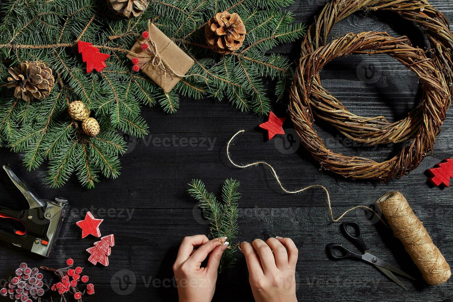 Manufacturer of Christmas decor with their own hands. Christmas wreath for the holiday. The new year celebration. Top view photo