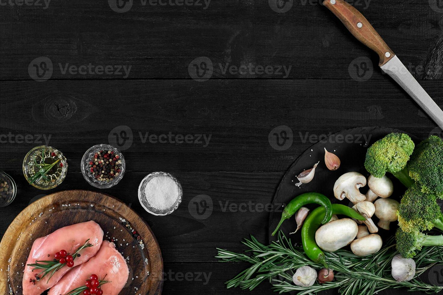 Raw chicken breast fillets on wooden cutting board with herbs and spices. Top view with copy space photo