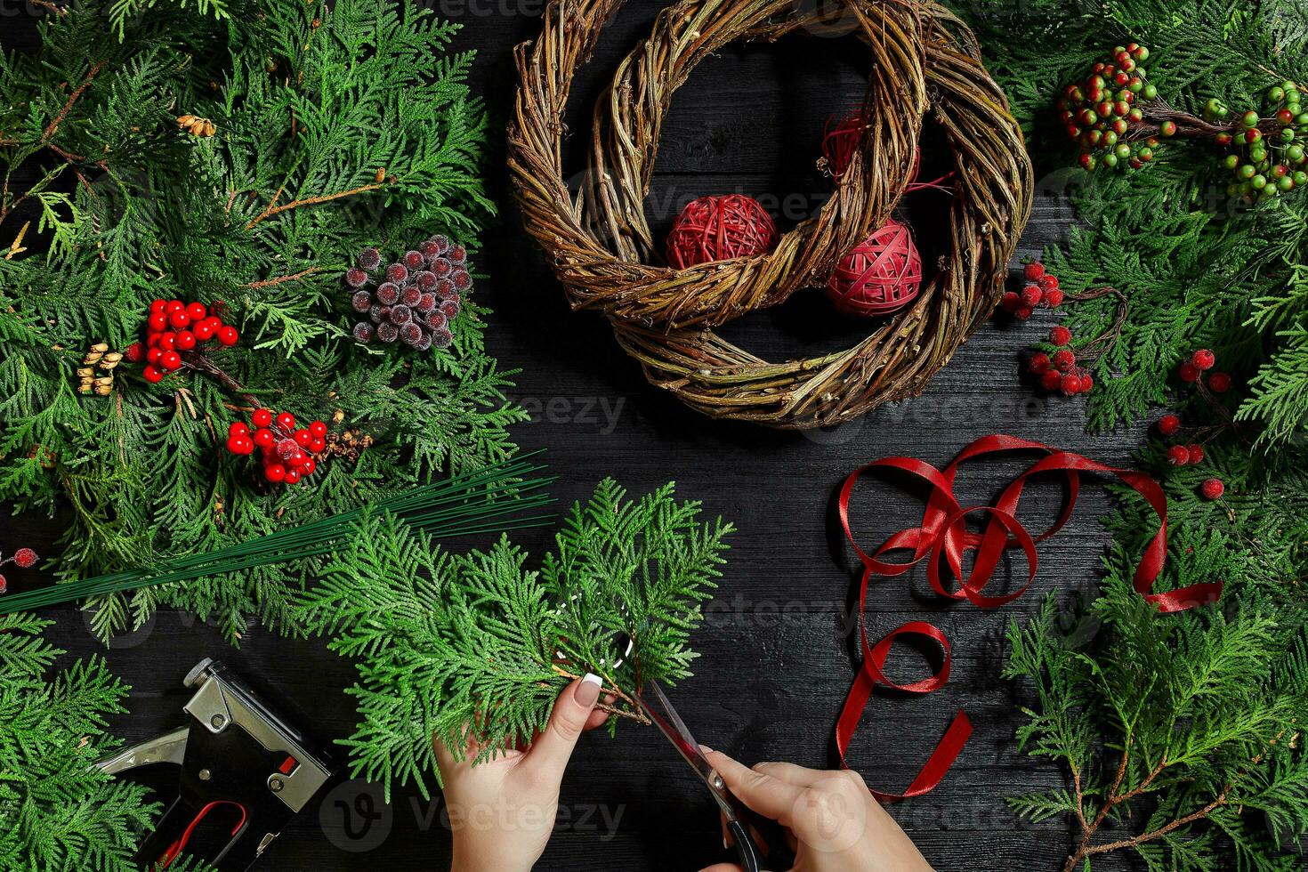 Manufacturer of Christmas decor with their own hands. Christmas wreath for the holiday. The new year celebration. Top view photo