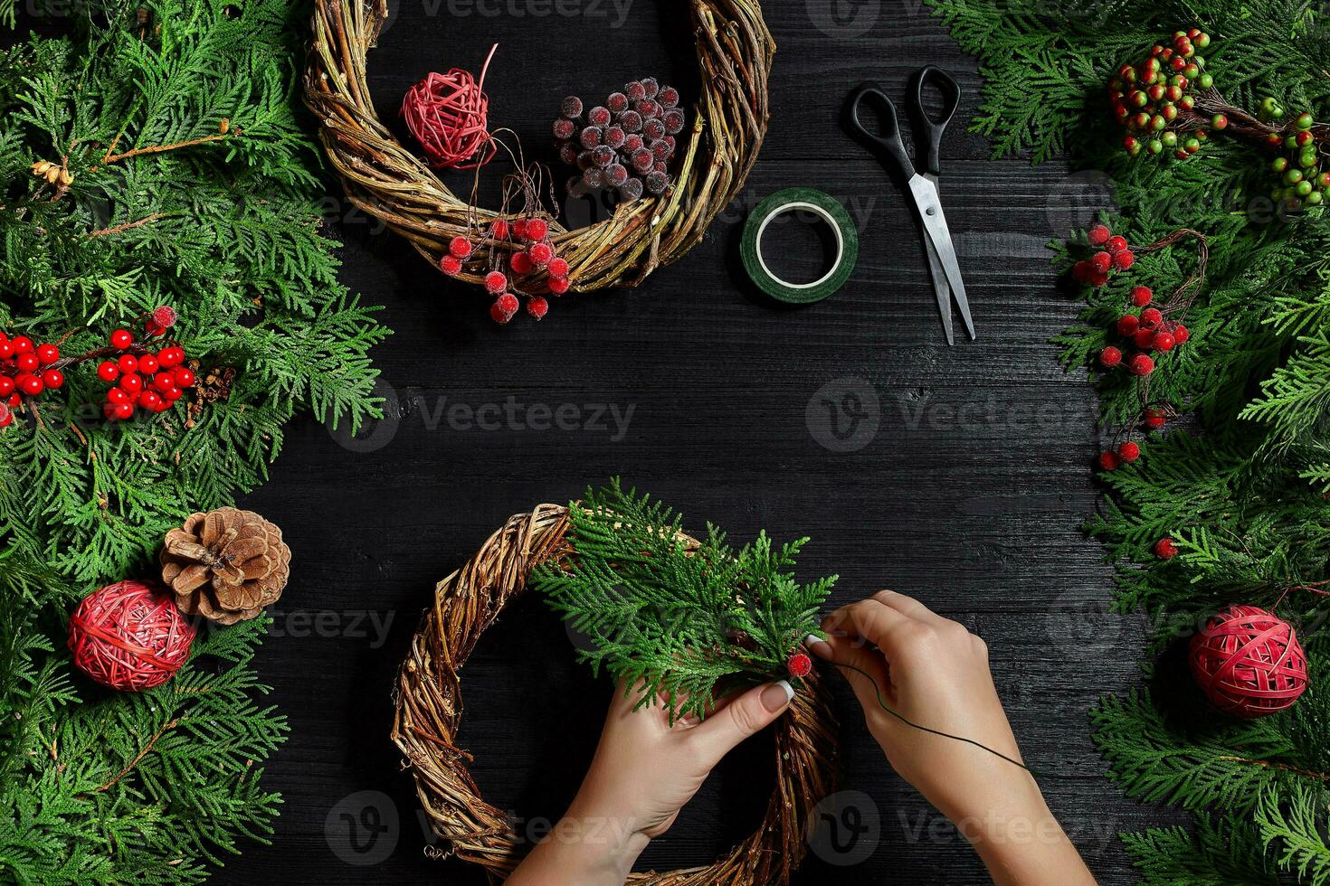 Manufacturer of Christmas decor with their own hands. Christmas wreath for the holiday. The new year celebration. Top view photo