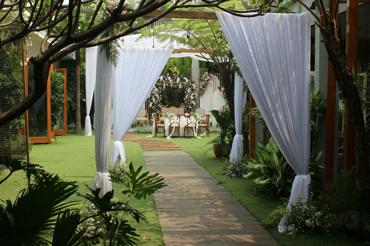 wedding altar and row of brown and white chairs shot at low angle prepared on the beautiful park or garden photo
