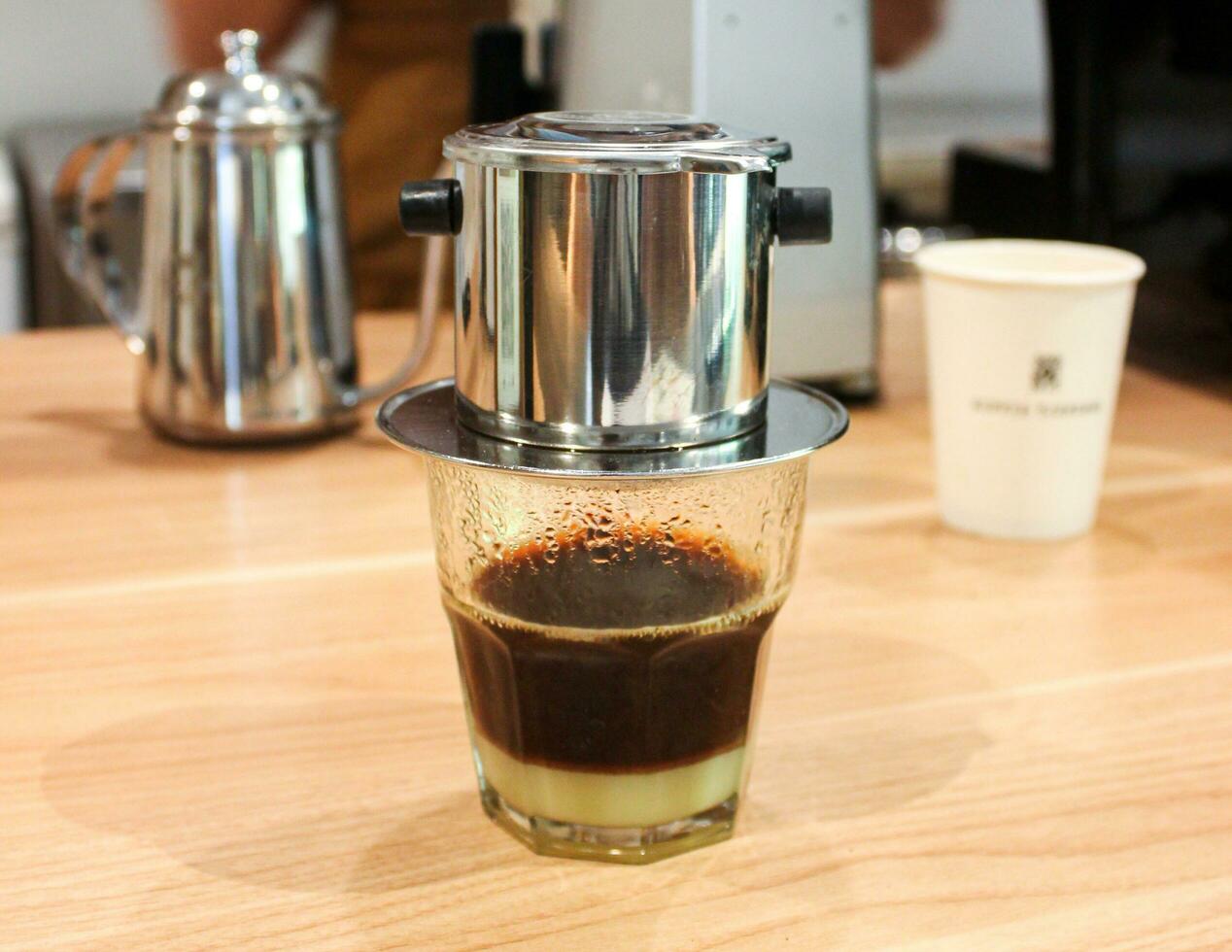 Vietnam Style Drip Coffee with Condensed Milk at the Bottom to Add Sweetness, Close Up photo