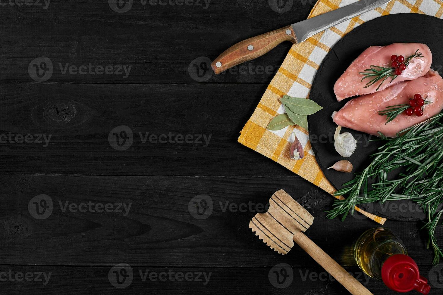 Raw chicken fillet with cooking ingredients on black slate table. Food background. Top view, copy space. photo