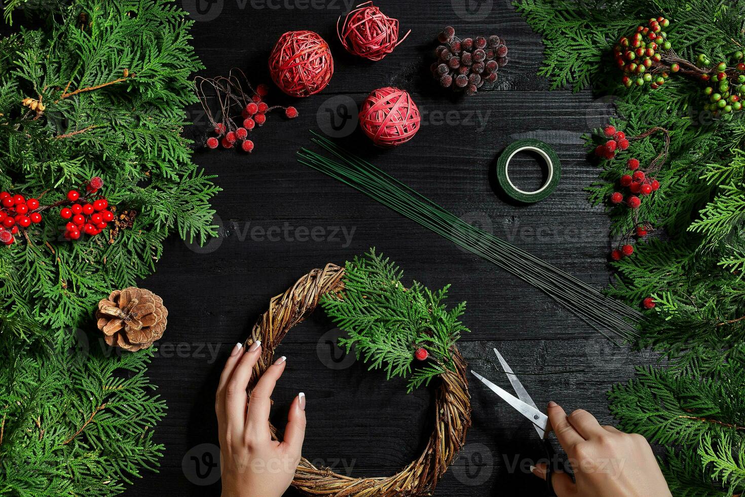 Manufacturer of Christmas decor with their own hands. Christmas wreath for the holiday. The new year celebration. Top view photo