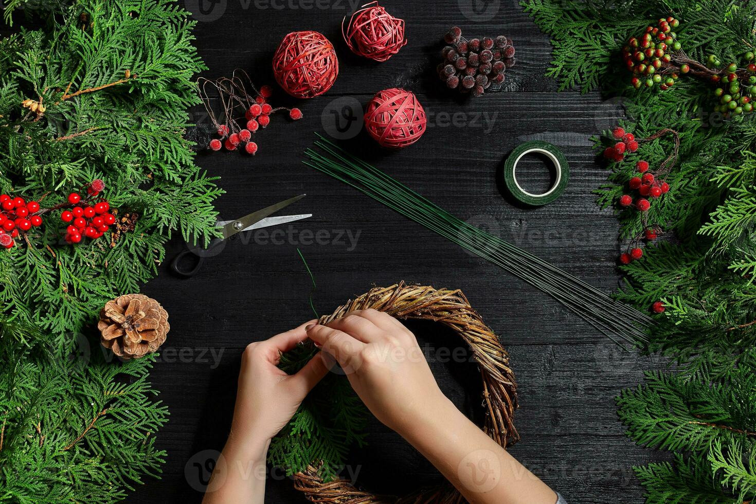 Manufacturer of Christmas decor with their own hands. Christmas wreath for the holiday. The new year celebration. Top view photo