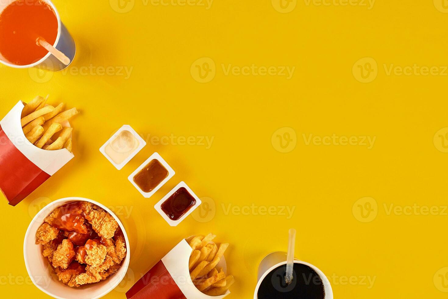 Fast food dish on yellow background. Fast food set fried chicken and french fries. Take away fast food. photo