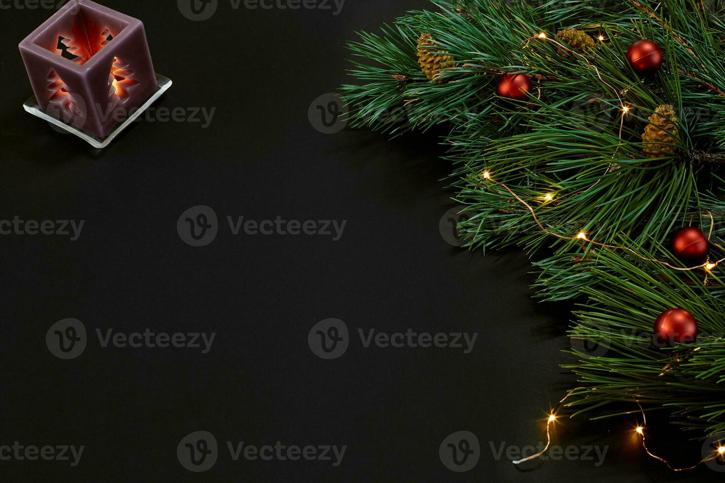 Christmas. Xmas toys and spruce branch on black background top view. Space for text photo