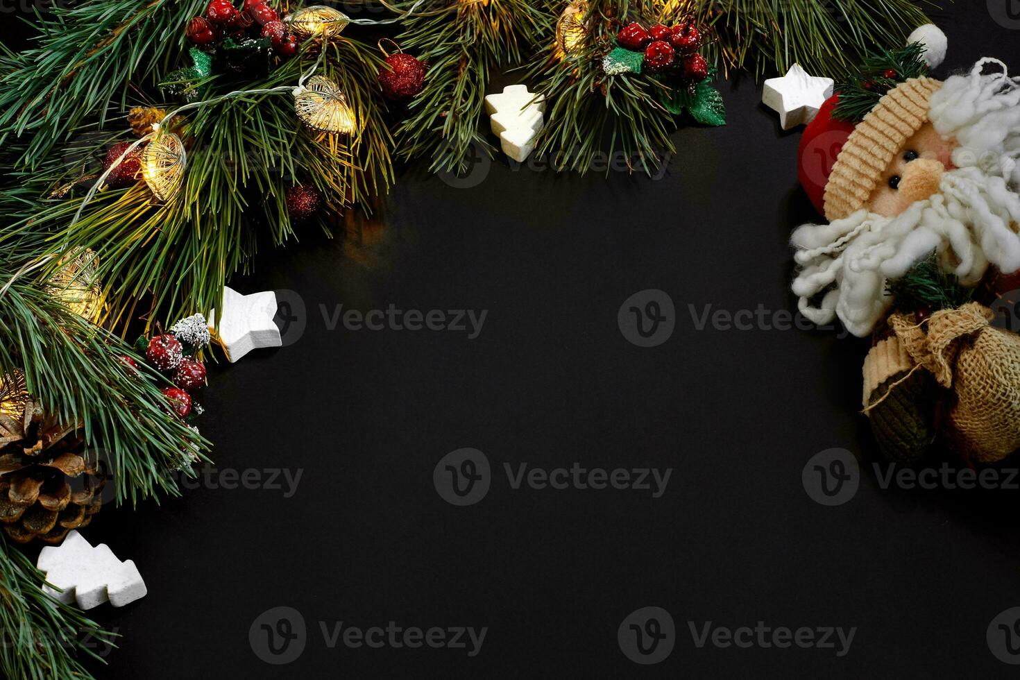 Christmas. Xmas toys and spruce branch on black background top view. Space for text photo