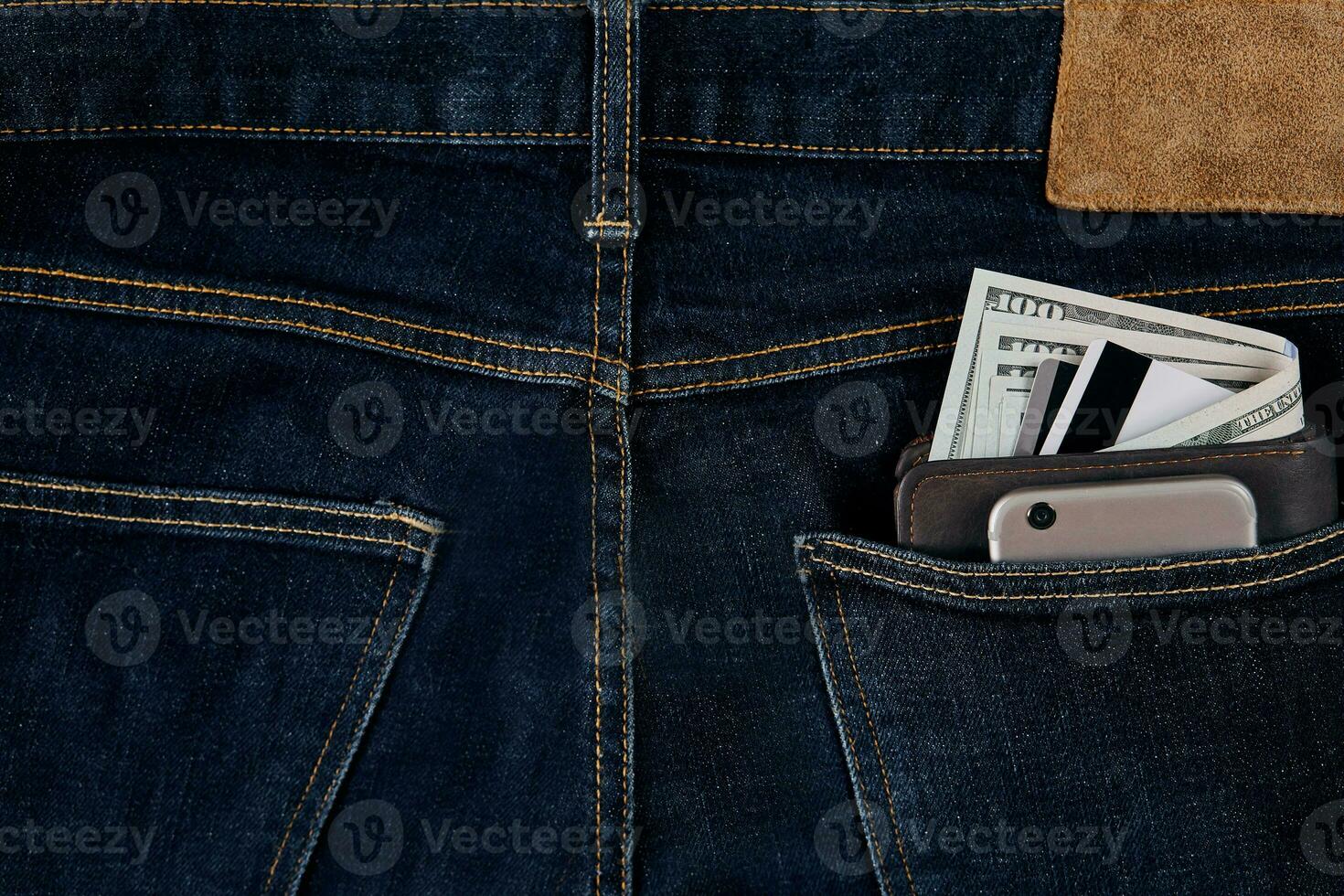 Money, Debit card and Credit card are in pocket of blue jean on wooden background with copy space. photo