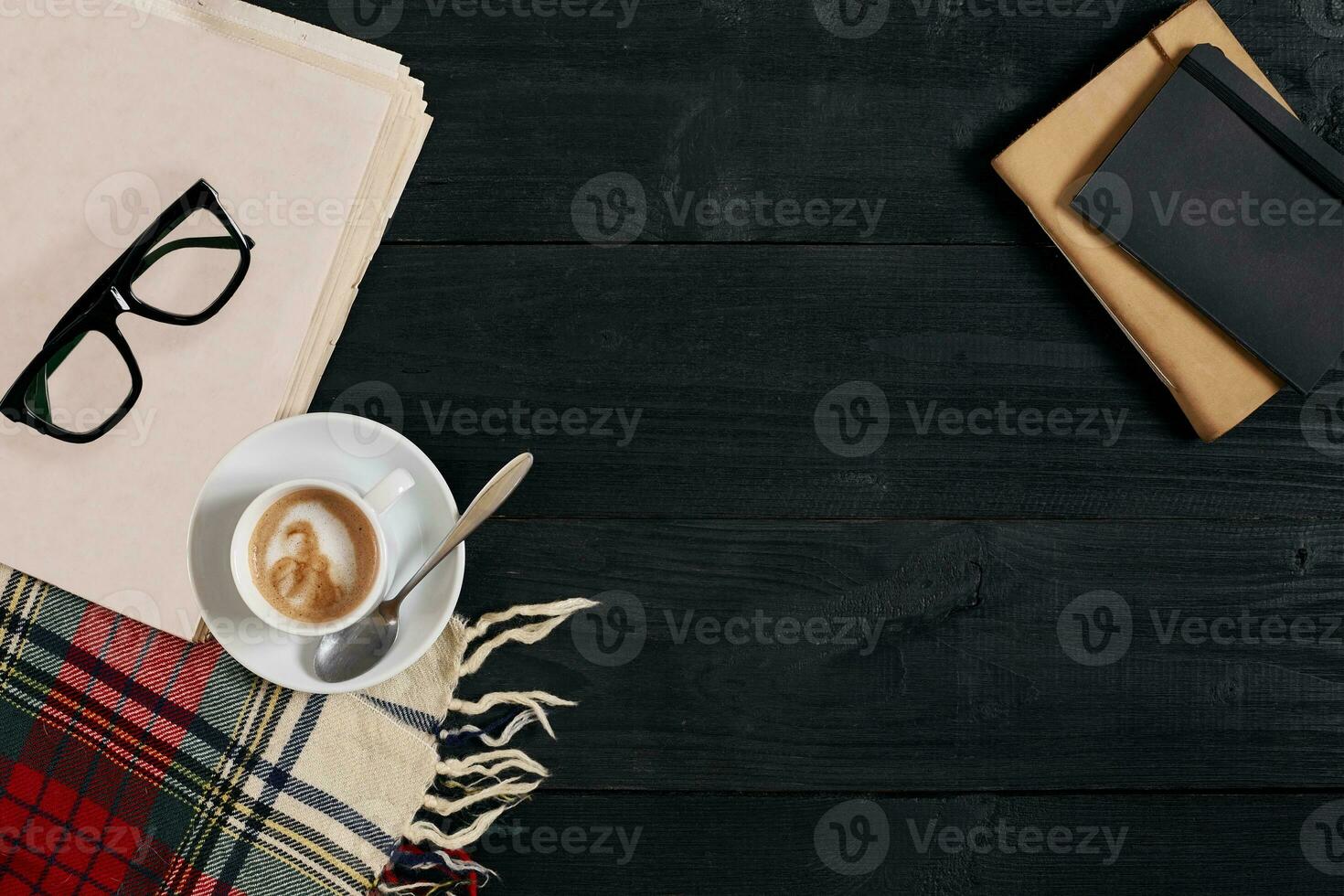 Workspace with newspaper, coffee cup, scarf, glasses. Stylish office desk. Autumn or Winter concept. Flat lay, top view photo