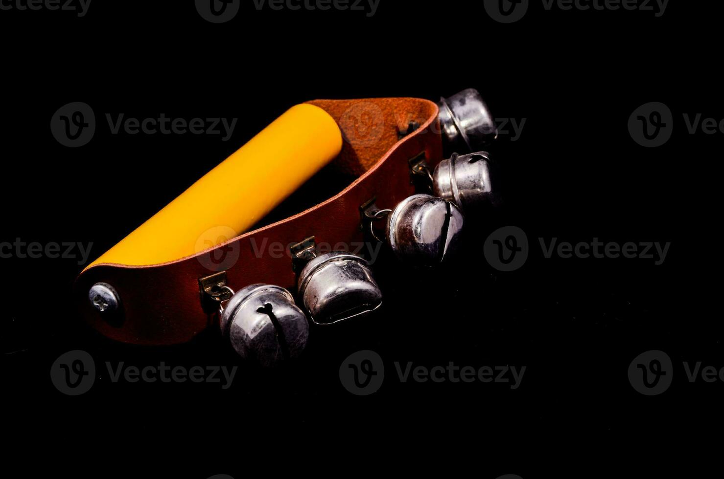 Hand Bell instrument on black background photo