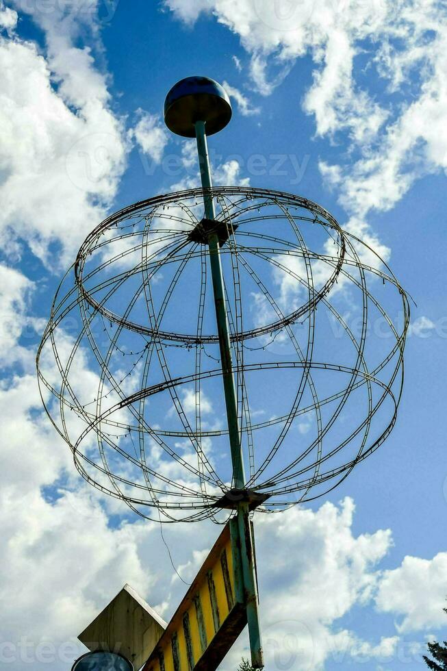 a metal globe sculpture photo