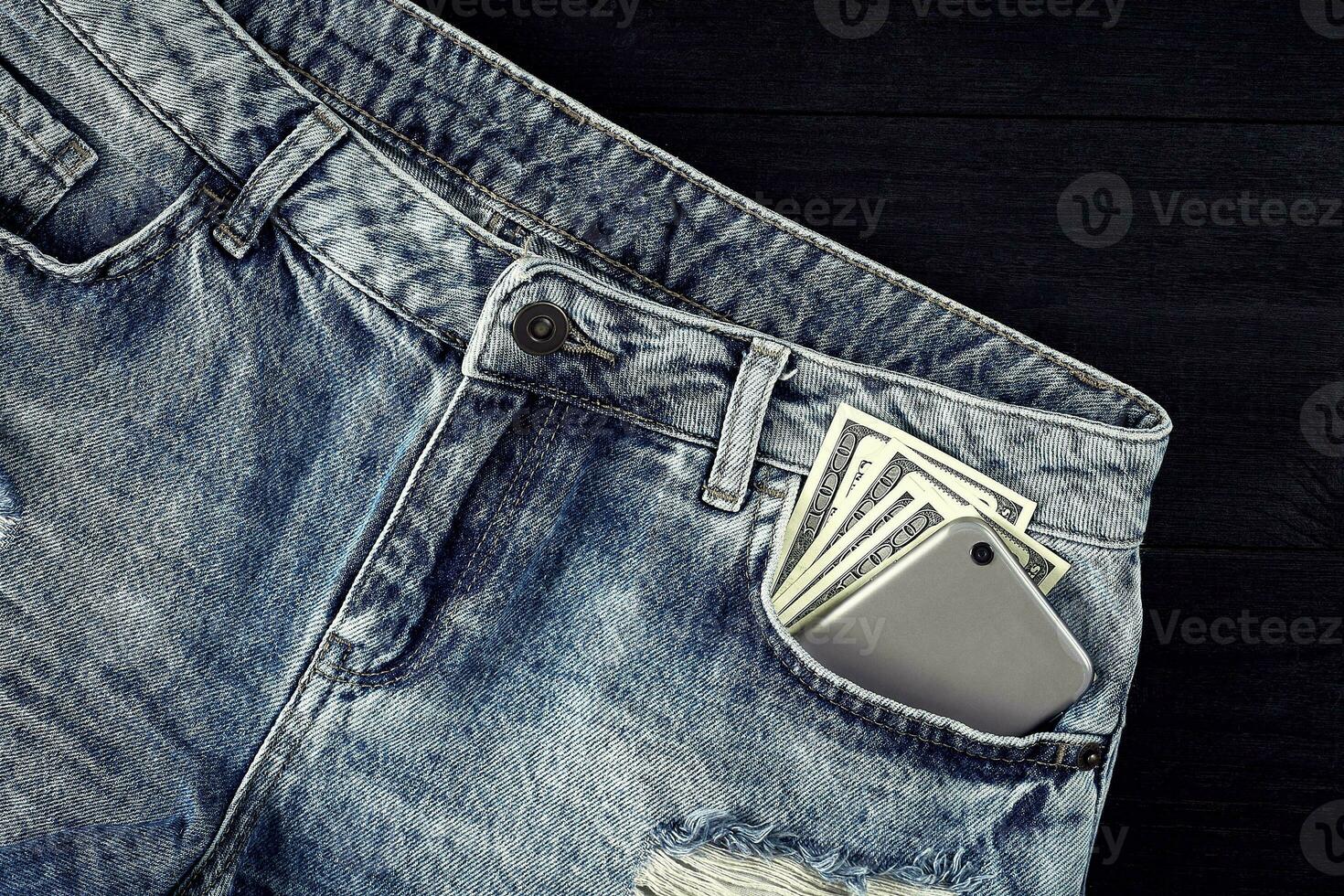 Cash and smart in your jeans pocket. Still life. photo