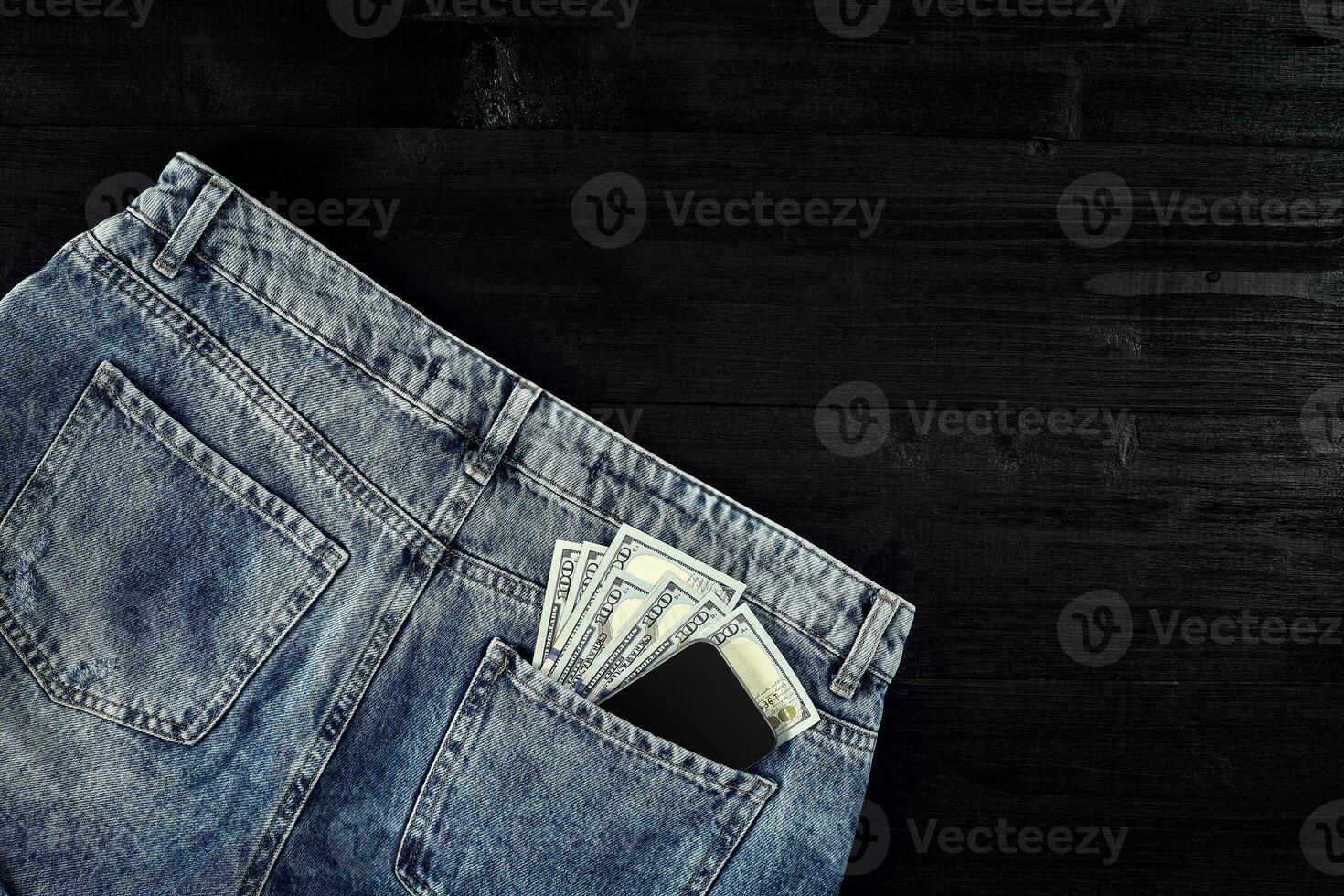 Pocket money. Dollar in hip pocket of worn blue jeans. Close-up. photo