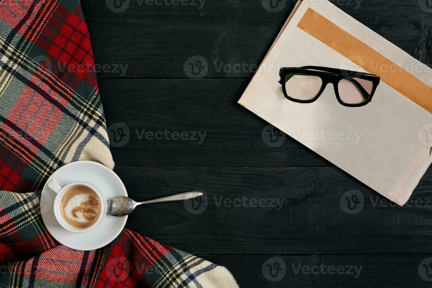 Workspace with newspaper, coffee cup, scarf, glasses. Stylish office desk. Autumn or Winter concept. Flat lay, top view photo