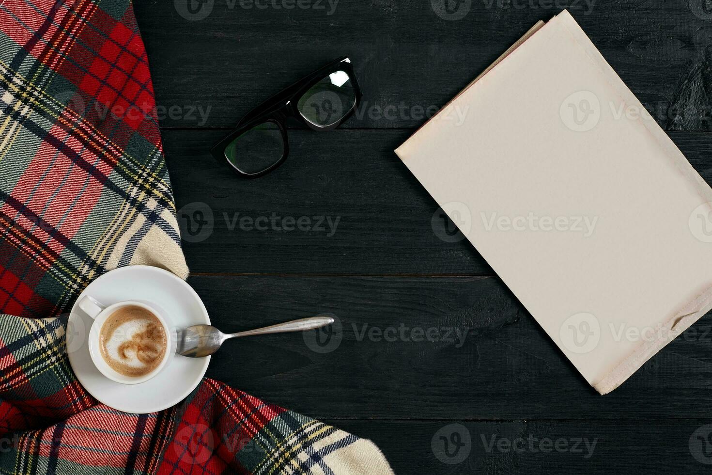 Workspace with newspaper, coffee cup, scarf, glasses. Stylish office desk. Autumn or Winter concept. Flat lay, top view photo