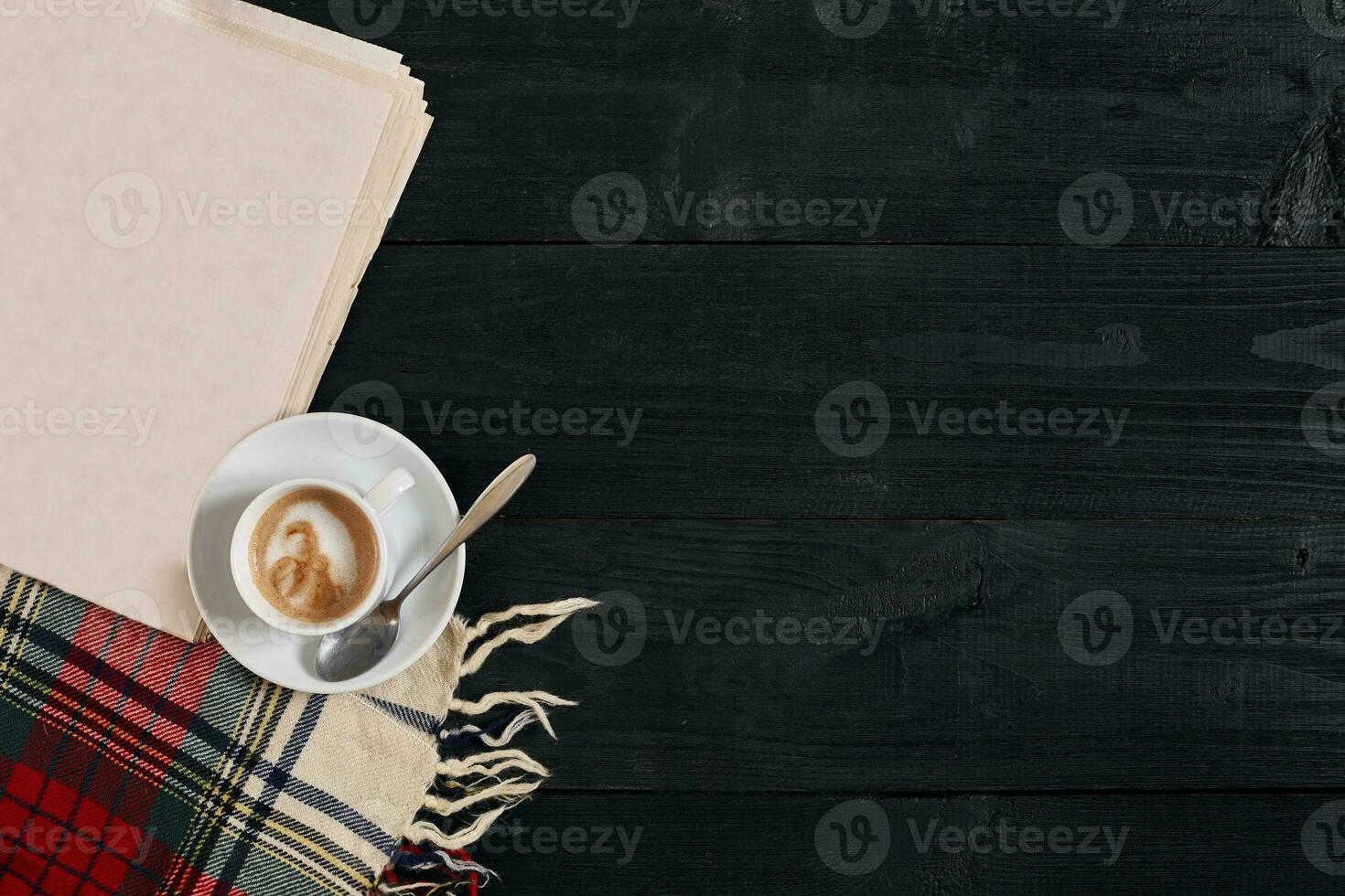 Workspace with newspaper, coffee cup, scarf. Stylish office desk. Autumn or Winter concept. Flat lay, top view photo