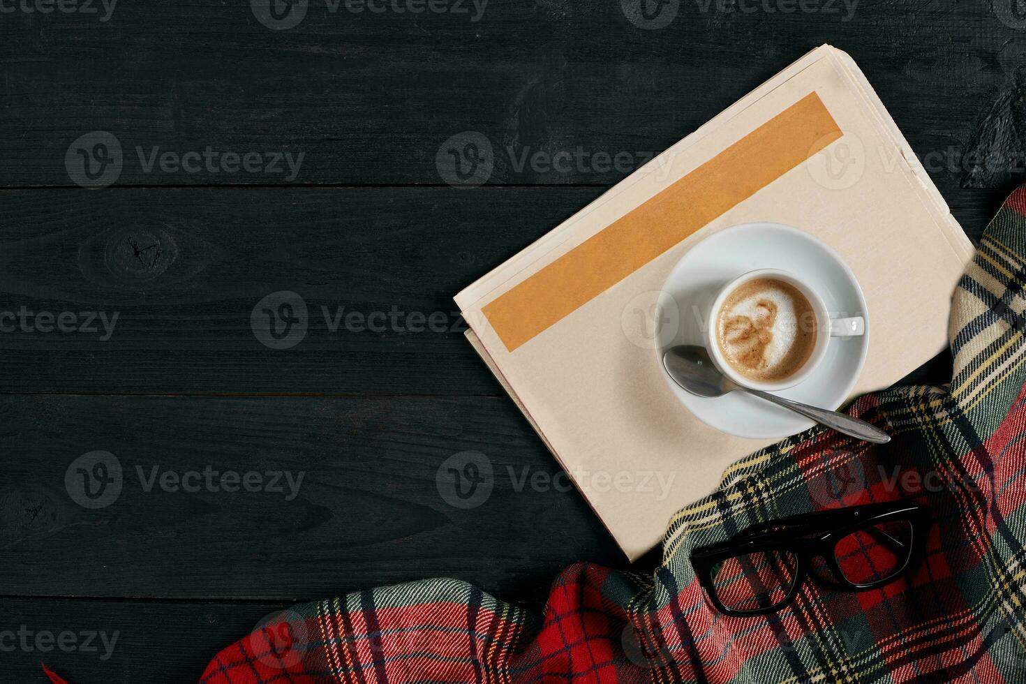 Workspace with newspaper, coffee cup, scarf, glasses. Stylish office desk. Autumn or Winter concept. Flat lay, top view photo