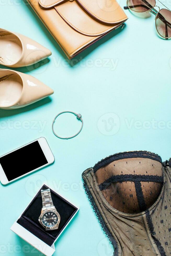Women's clothes and accessories on a turquoise background photo