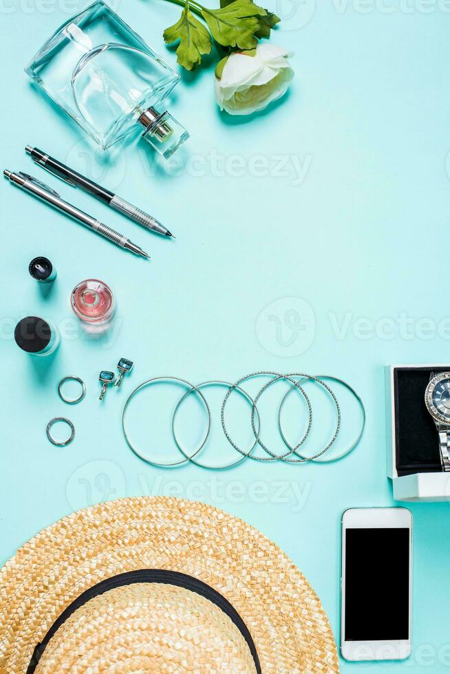 Women's clothes and accessories on a turquoise background photo