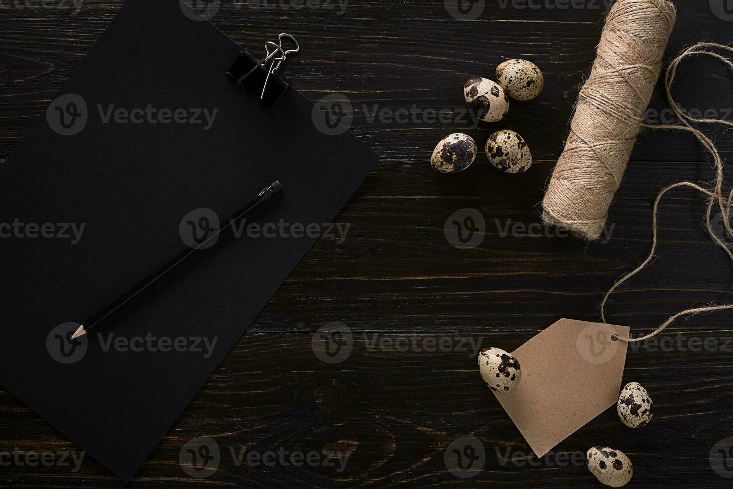 quail eggs in a nest, place for text on wooden rustic background top view close up photo