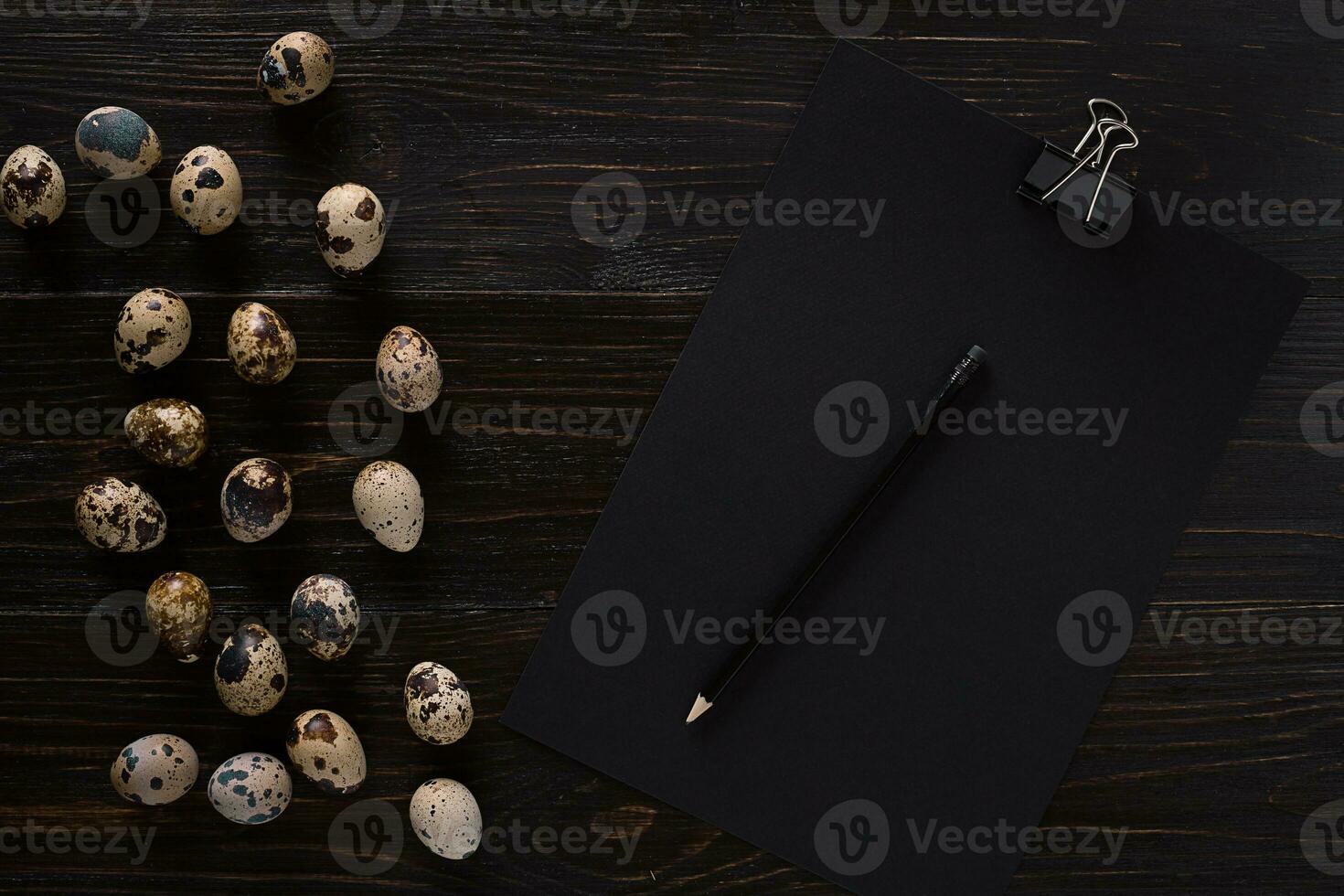 quail eggs, place for text on wooden rustic background top view close up photo