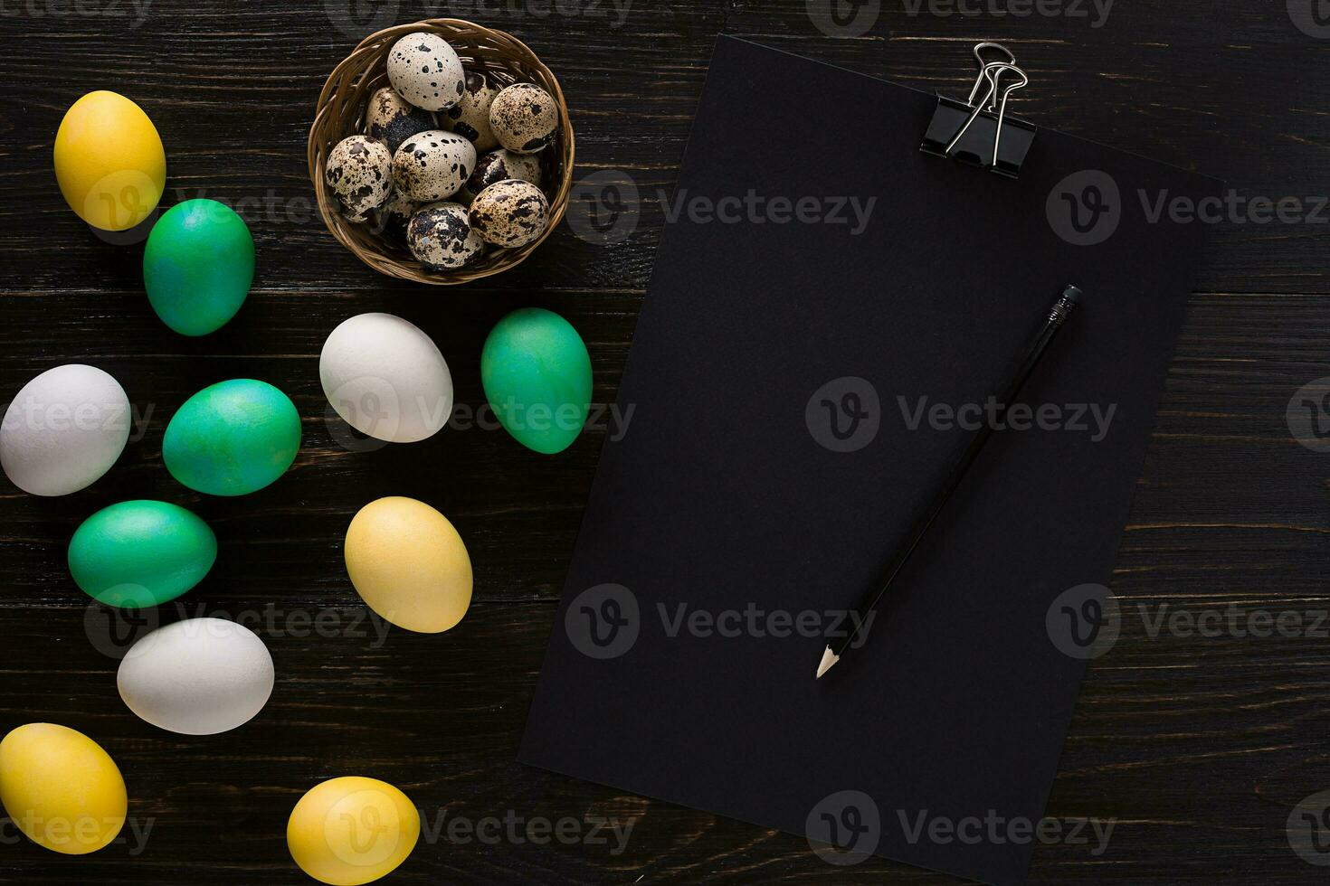 Greeting card with paschal eggs on rustic, wood table photo