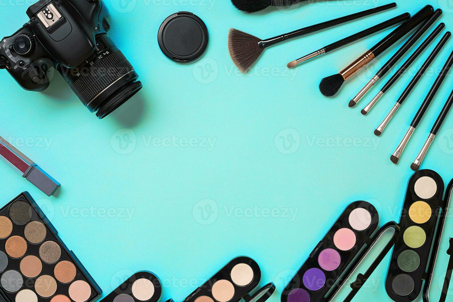 Various cosmetics and brushes on blue background photo