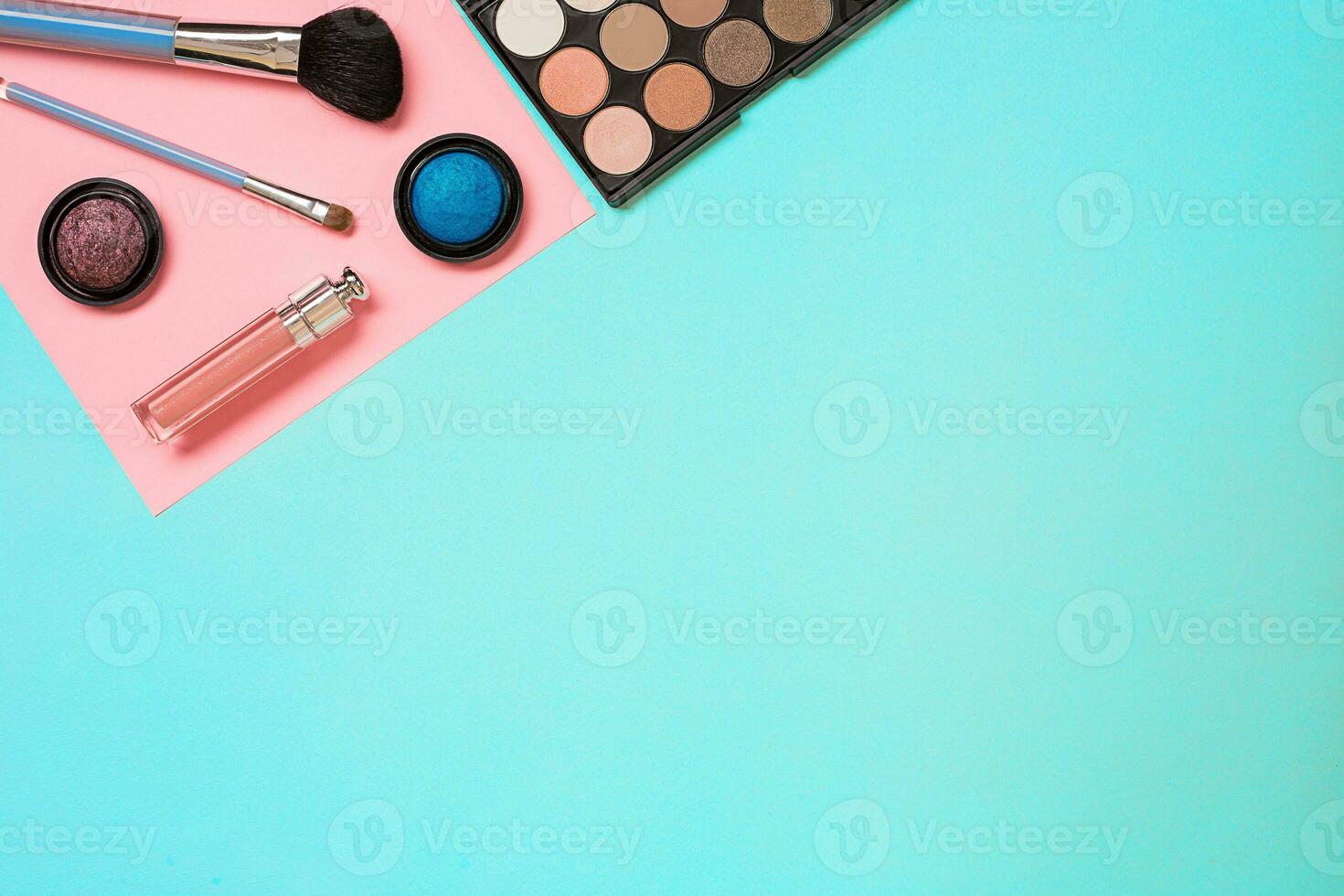 Various cosmetics and brushes on blue background photo