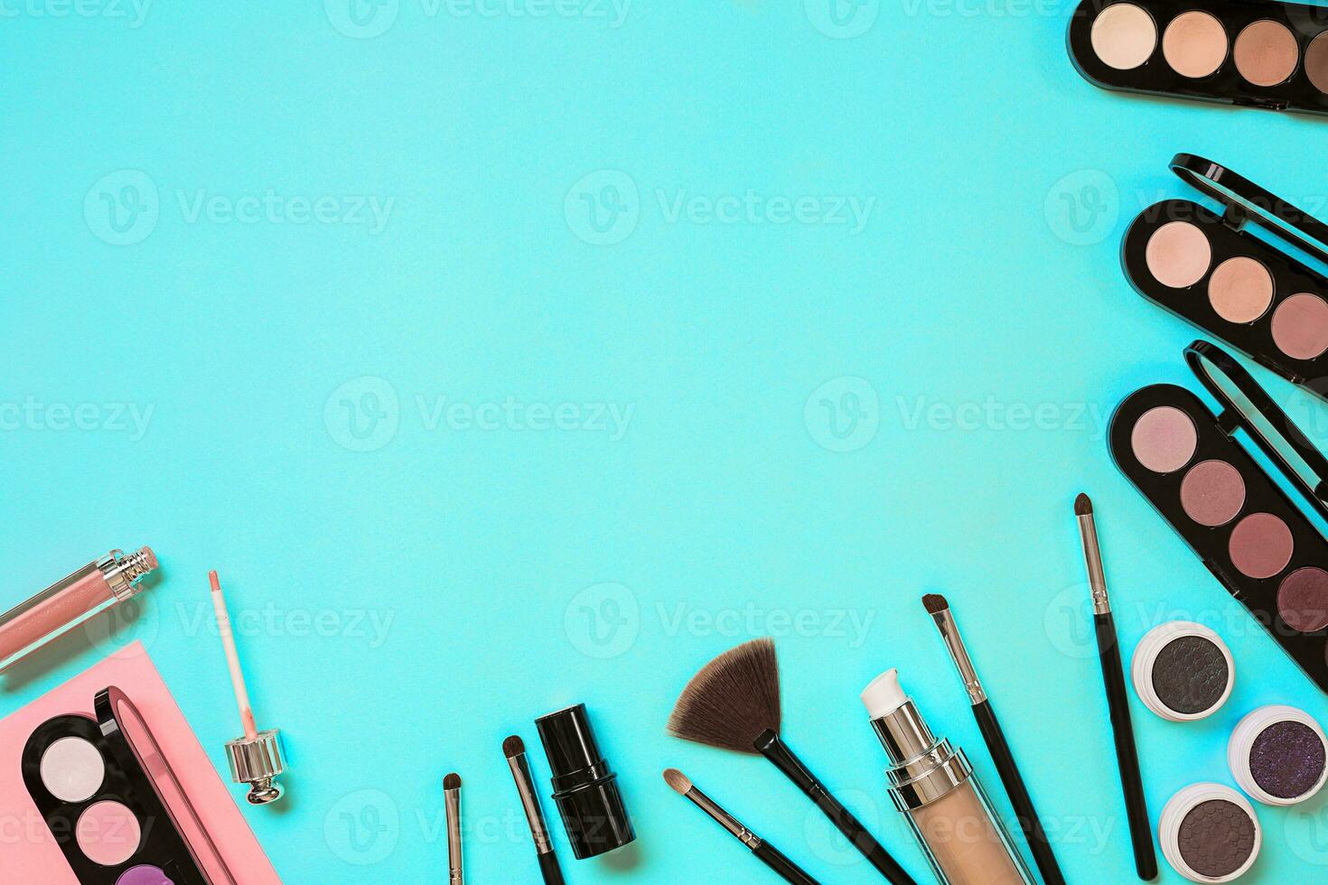 Various cosmetics and brushes on blue background photo