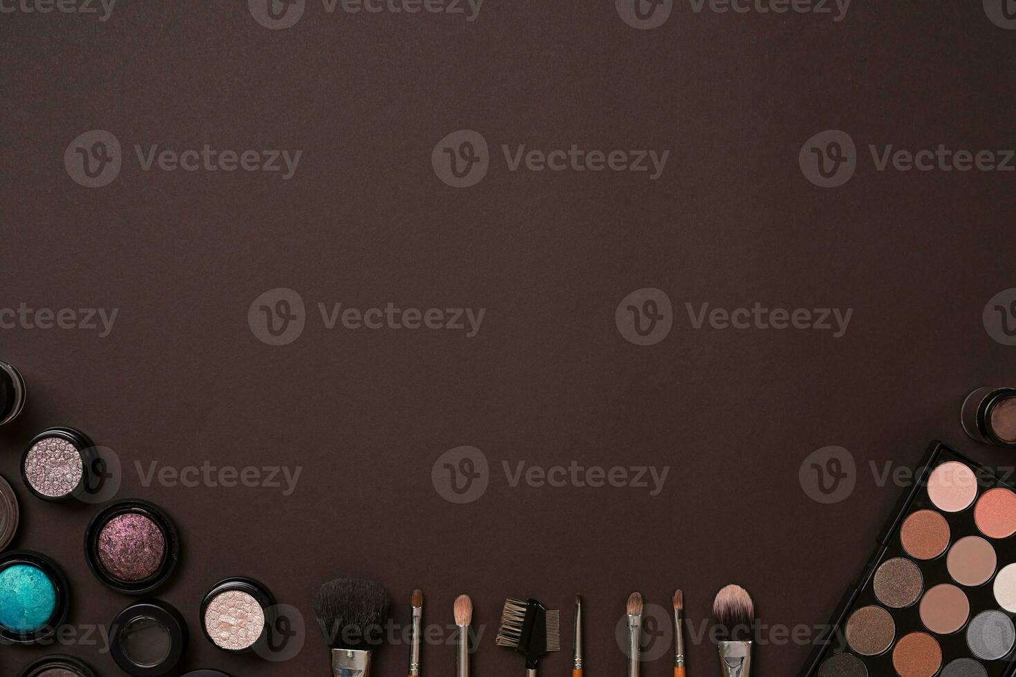 brush for makeup, eye shadow, view from above. On a brown background photo