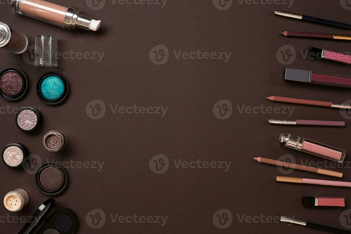 Make up essentials. Set of professional make up brushes, creams and shadows in jars on dark background. photo