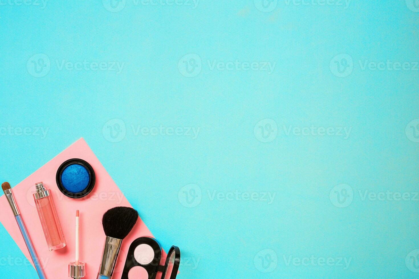 Various cosmetics and brushes on blue background photo