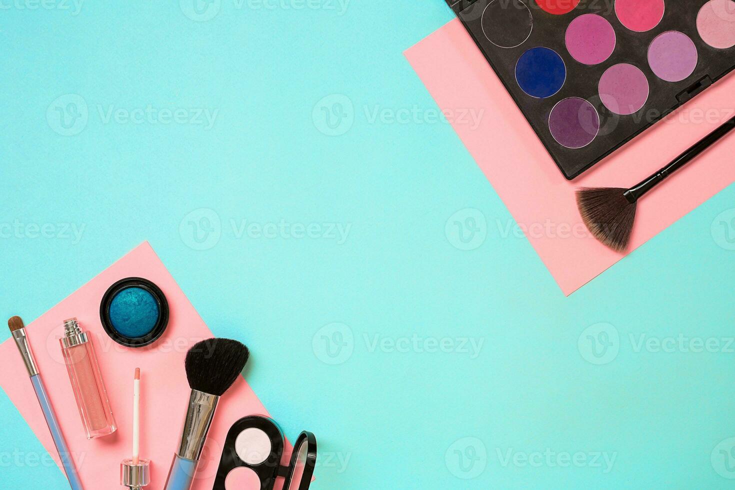 Make up essentials. Set of professional make up brushes, creams and shadows in jars on blue background. photo