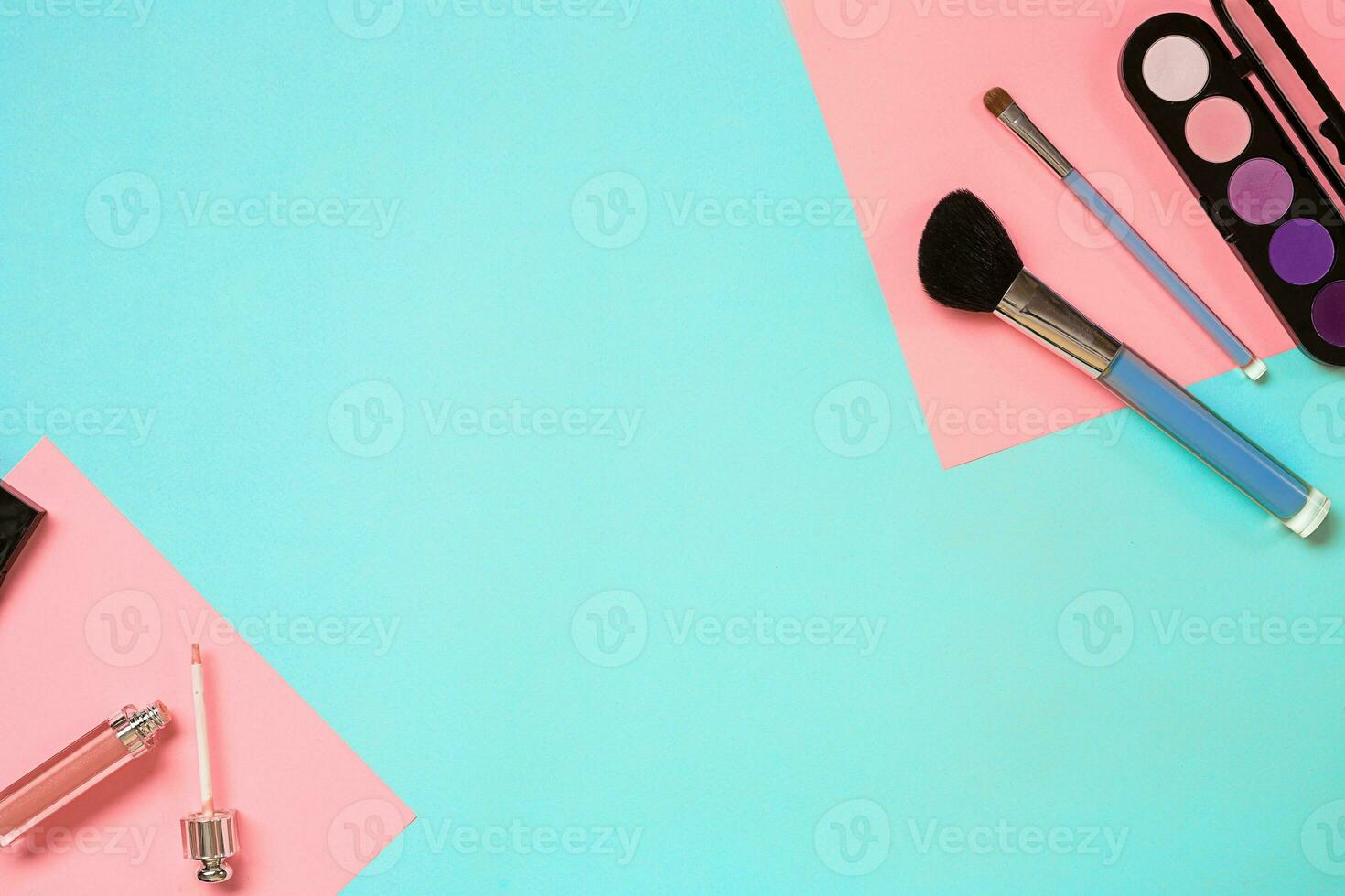 Make up essentials. Set of professional make up brushes, creams and shadows in jars on blue background. photo