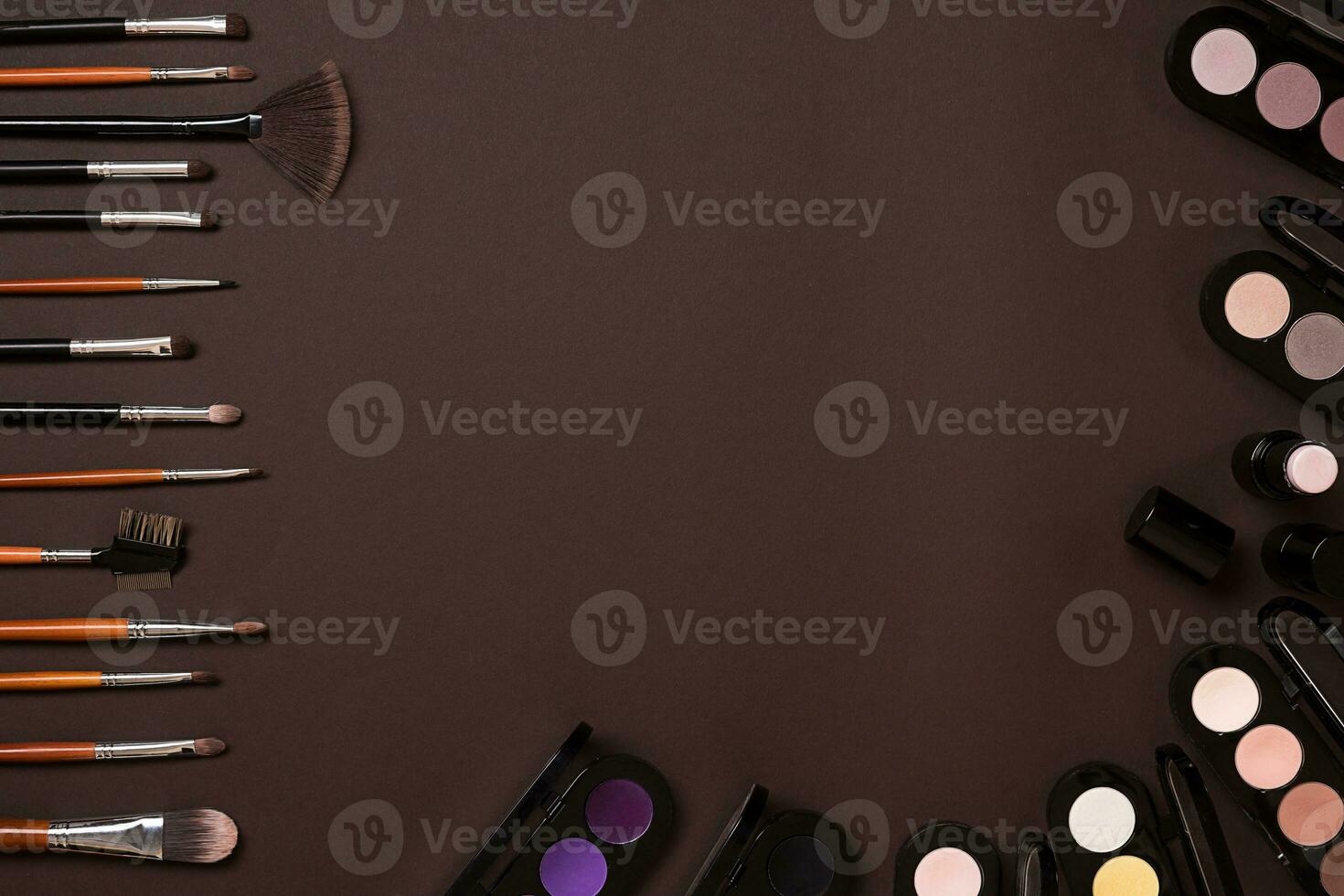 Various cosmetics and brushes on brown background photo