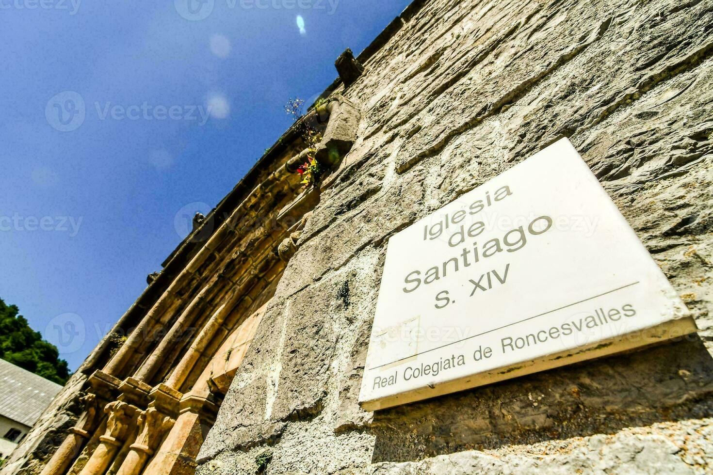 stone building with a sign that says iglesia de santiago photo