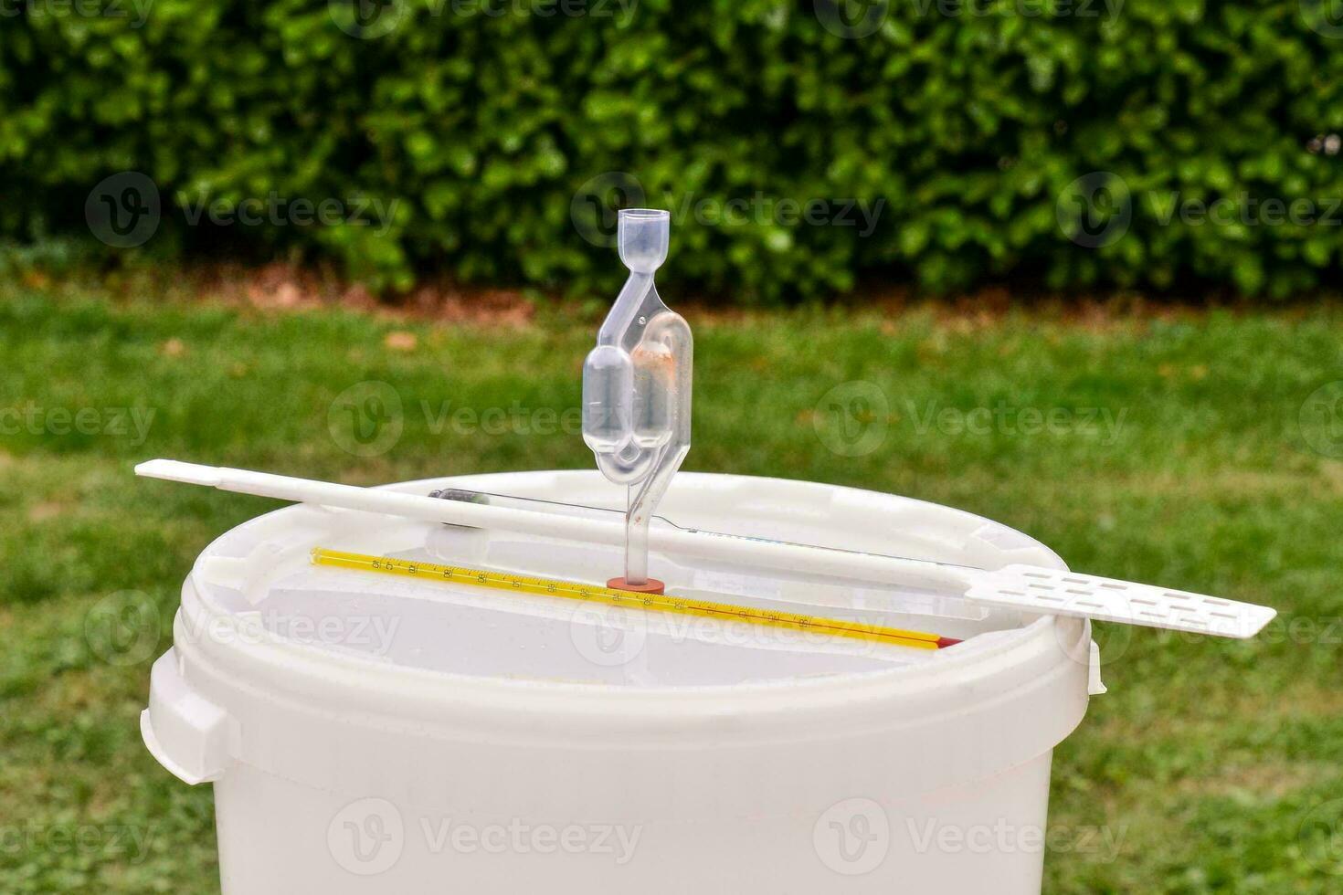 a bucket with a measuring stick and a spoon photo