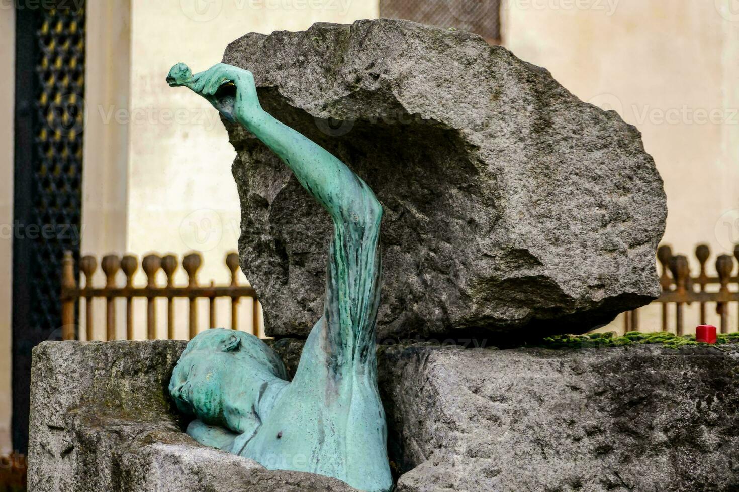 a statue of a woman holding a rock in her hand photo
