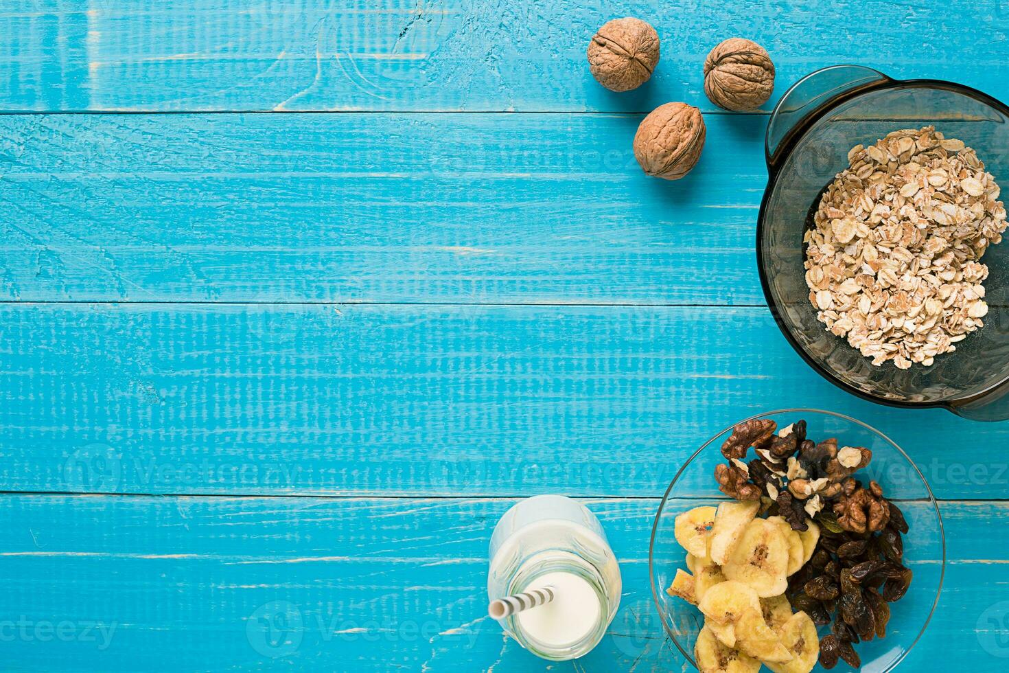 Porridge, oats, milk and banana on the table photo