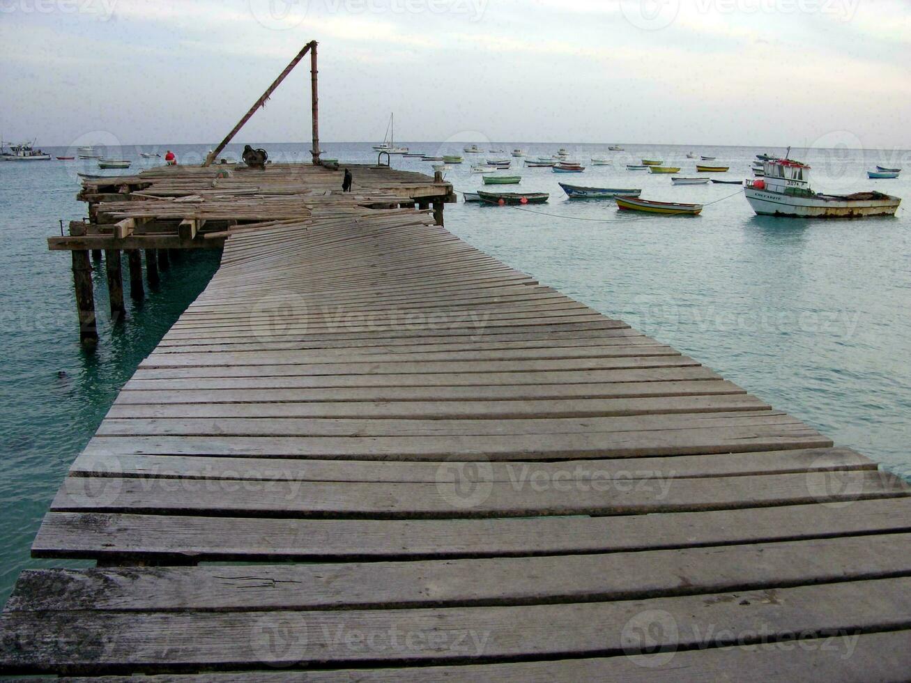 a wooden bridge over the water photo