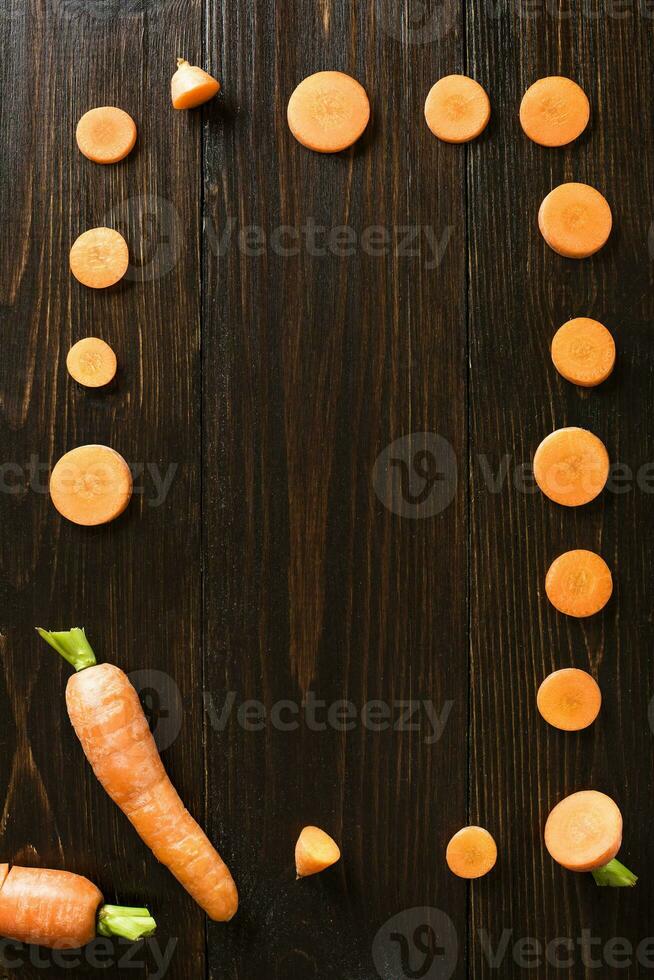 sliced carrot on slate and wooden counter top background photo