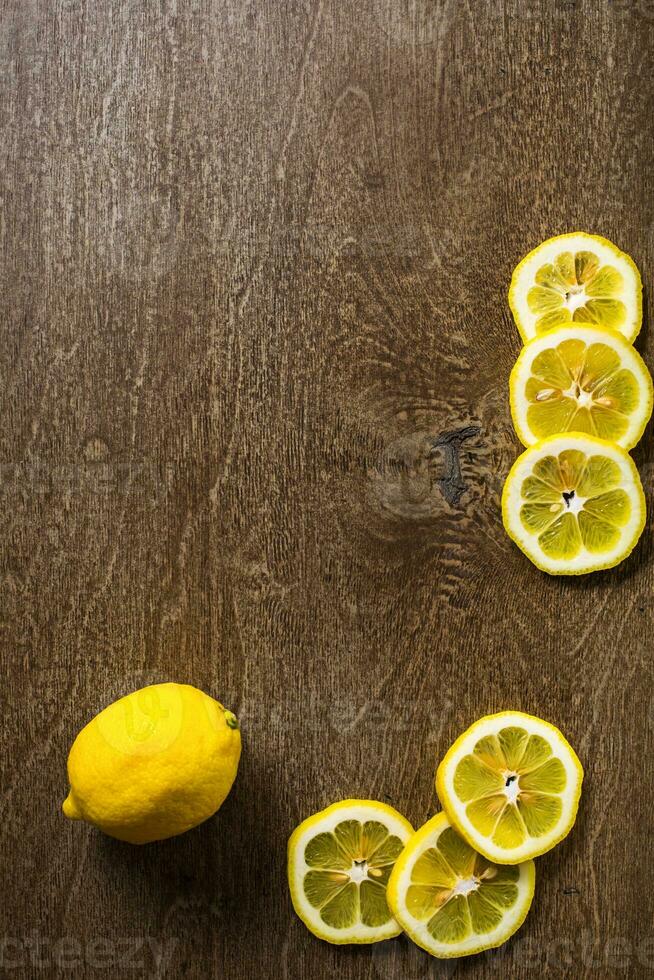 sliced lemon, lime on slate and wooden counter top background photo