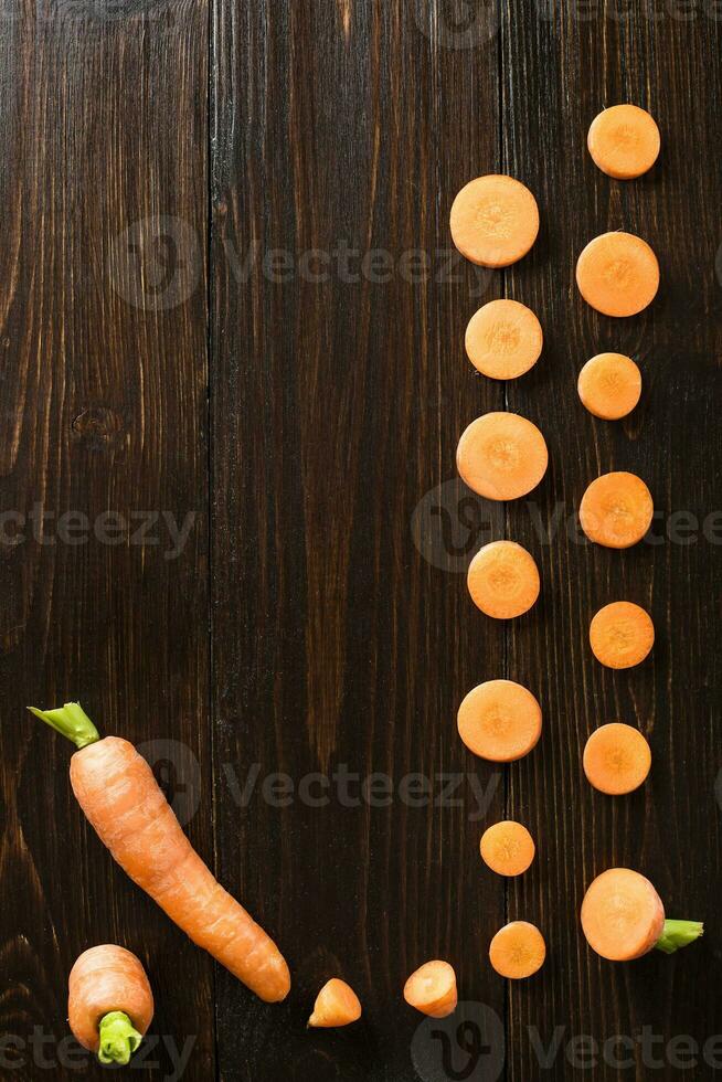 sliced carrot on slate and wooden counter top background photo