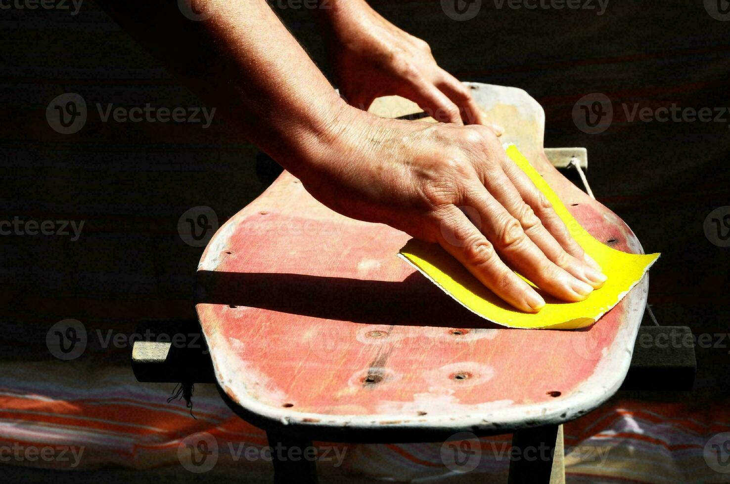 a person is sanding a skateboard photo