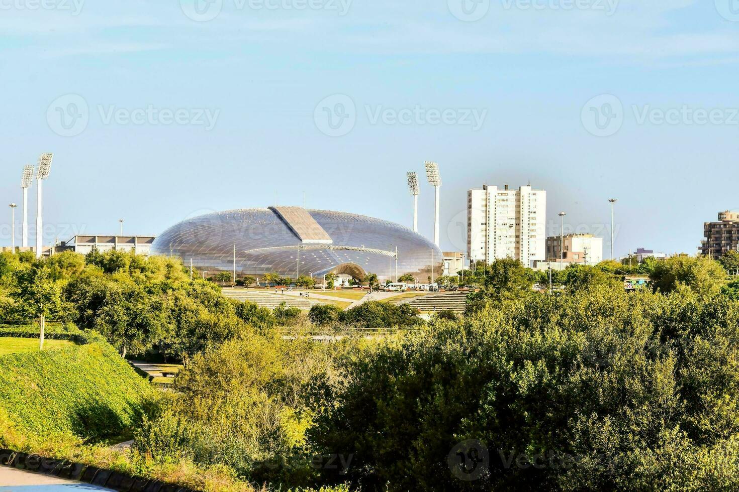 the stadium is located in the middle of a green area photo